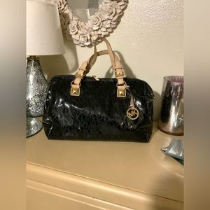 Black Micha Kors Patent Leather Signature Handbag.